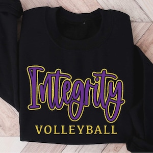 May include: Black sweatshirt with the words "Integrity Volleyball" in purple and gold lettering.