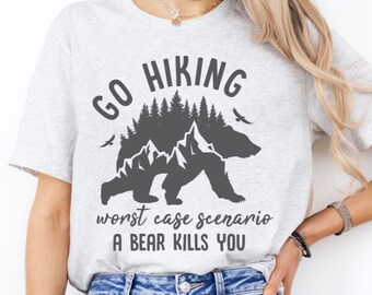 May include: Gray t-shirt with a graphic of a bear walking through a forest with mountains and the text "Go Hiking worst case scenario a bear kills you".
