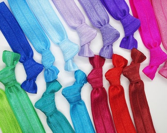 May include: A set of 14 colorful hair ties in various shades of blue, green, purple, pink, and red. The hair ties are made of elastic material and are tied in a bow.