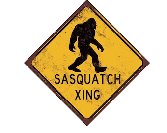 May include: A yellow diamond-shaped warning sign with a distressed, rusty look. It features a black silhouette of a Sasquatch walking and the text "Sasquatch Xing".