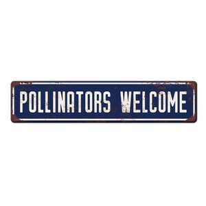 May include: A blue metal sign with white text that reads "Pollinators Welcome". The sign has a rustic, weathered look.