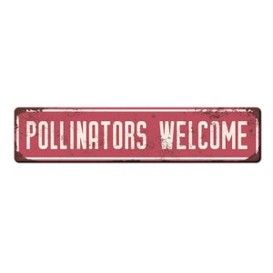 May include: A red metal sign with white text that reads "Pollinators Welcome". The sign has a distressed, rusty look.