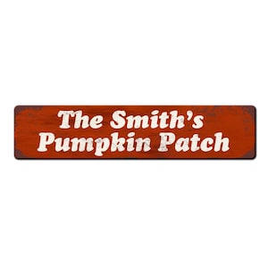 May include: A rusty red metal sign with white text that reads "The Smith's Pumpkin Patch".