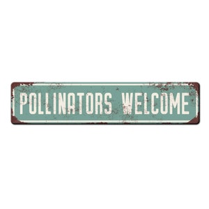 May include: A vintage-style metal sign with a distressed, rusty look. The sign is painted a light blue-green color and has white lettering that reads "POLLINATORS WELCOME".
