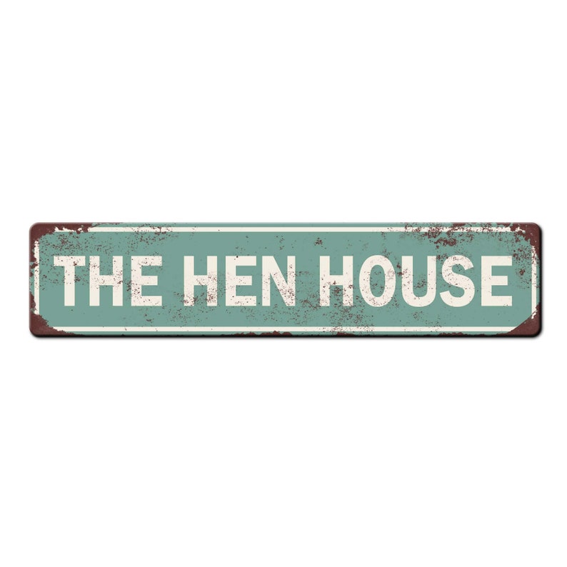 May include: A rustic green metal sign with white text that reads "THE HEN HOUSE".