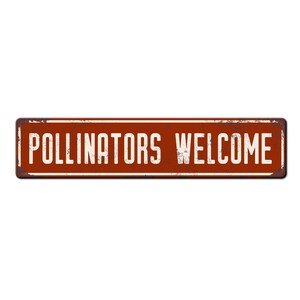May include: A rusty red metal sign with white text that reads "Pollinators Welcome".