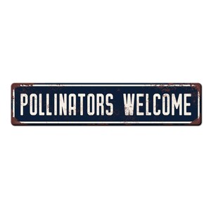 May include: A blue metal sign with white text that reads "Pollinators Welcome". The sign has a rustic, weathered look.