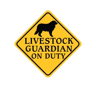 May include: Yellow diamond-shaped warning sign with a black silhouette of a dog and the text "Livestock Guardian On Duty".