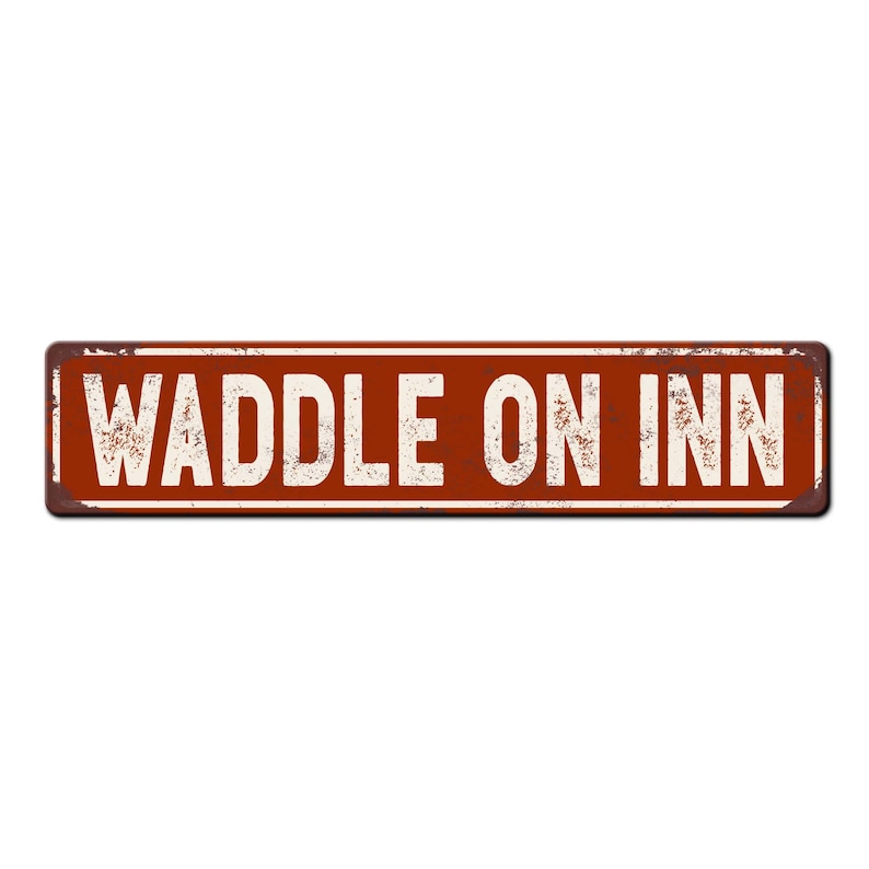 May include: A rusty metal sign with the text "Waddle On Inn" in white letters on a red background.