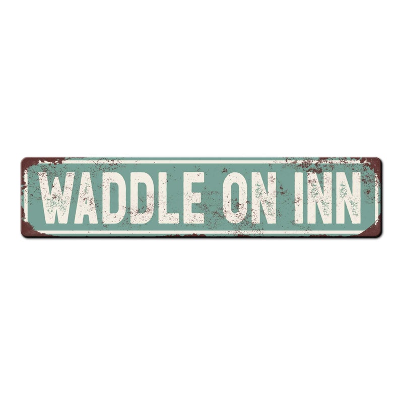 May include: A vintage-style metal sign with a rustic, weathered look. The sign is painted in a light blue color with a white border and the text "WADDLE ON INN" in white letters.