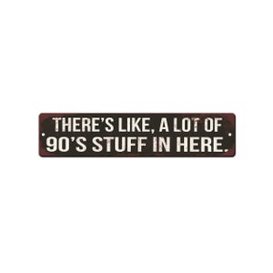May include: A rectangular metal sign with a dark brown, distressed background and rounded corners. The sign features the white, bold, sans-serif text: THERE'S LIKE, A LOT OF 90'S STUFF IN HERE. Small mounting holes are visible on the left and right sides.