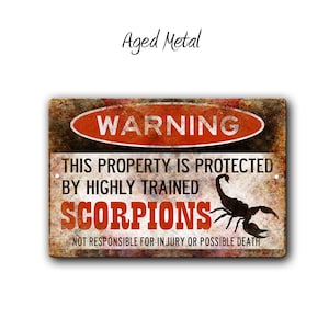 May include: A warning sign with a distressed metal look. The sign is red, black, and white with the text "WARNING" in a red circle. The text reads "This property is protected by highly trained scorpions. Not responsible for injury or possible death." A black scorpion is pictured on the sign.