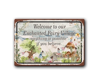 May include: A rectangular metal sign with a rusty brown border. The sign features a watercolor illustration of fairies in a whimsical village setting. Text reads "Welcome to our Enchanted Fairy Village, anything is possible if you believe."