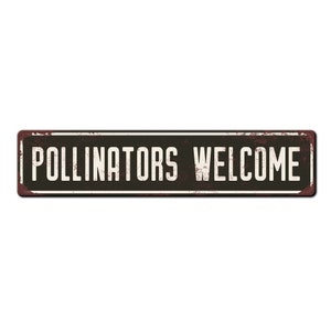 May include: A rusty metal sign with black lettering that reads "Pollinators Welcome".