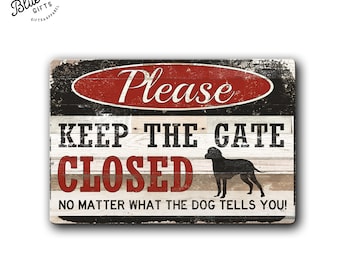 May include: A rustic wooden sign with black, white, and red paint. The sign reads "Please Keep The Gate Closed No Matter What The Dog Tells You!" with a silhouette of a dog in the middle.
