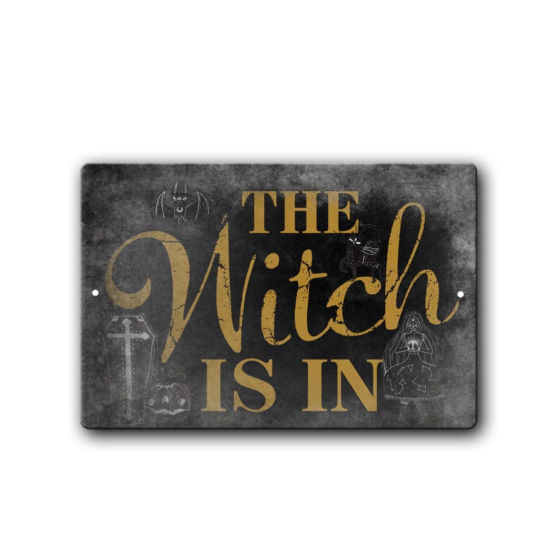 May include: A black and white sign with the text "The Witch Is In" in gold lettering. The sign has a distressed look and features various Halloween-themed images, including a coffin, a spider, a cat, and a witch.