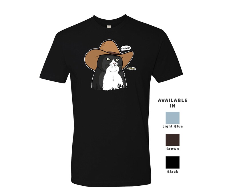 May include: Black and white cat wearing a brown cowboy hat with the word "MEOWDY" above it. The cat is wearing a black shirt with a white collar. The shirt is available in light blue, brown, and black.