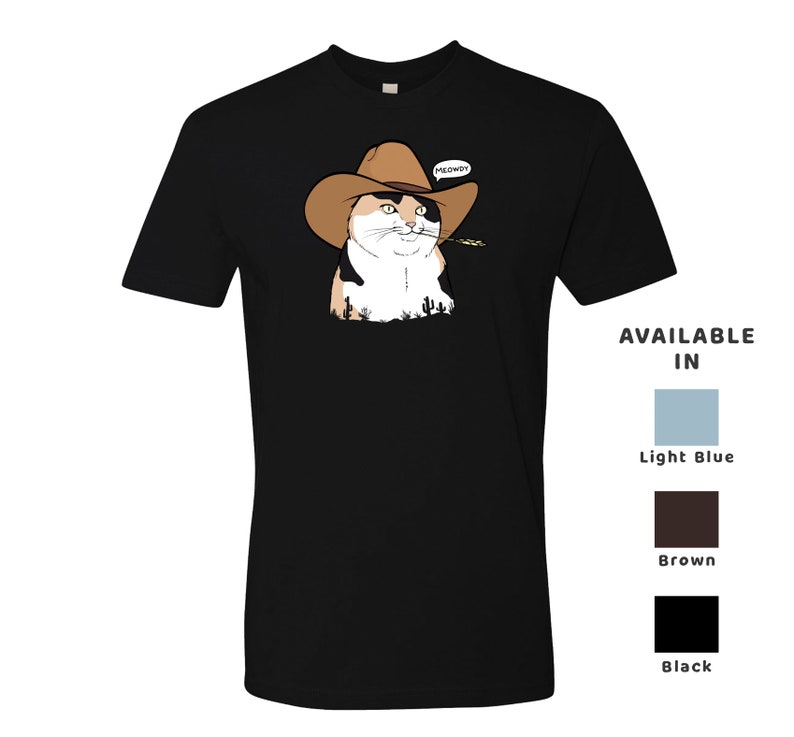 May include: Black t-shirt with a cartoon image of a calico cat wearing a cowboy hat and holding a piece of grass in its mouth. The cat is looking to the right and the text "MEOWDY!" is above the cat. The t-shirt is available in light blue, brown, and black.