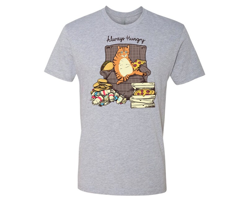 May include: A gray t-shirt with a graphic of an orange cat sitting in a chair with a pizza and other food around it. The text "Always Hungry" is above the cat.