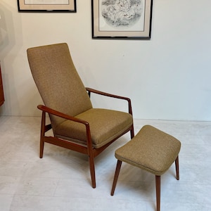 May include: A mid-century modern armchair and ottoman set with a brown tweed fabric and wooden frame. Two framed circular prints with black and white illustrations hang on the wall behind the furniture. The chair has a high back and armrests.