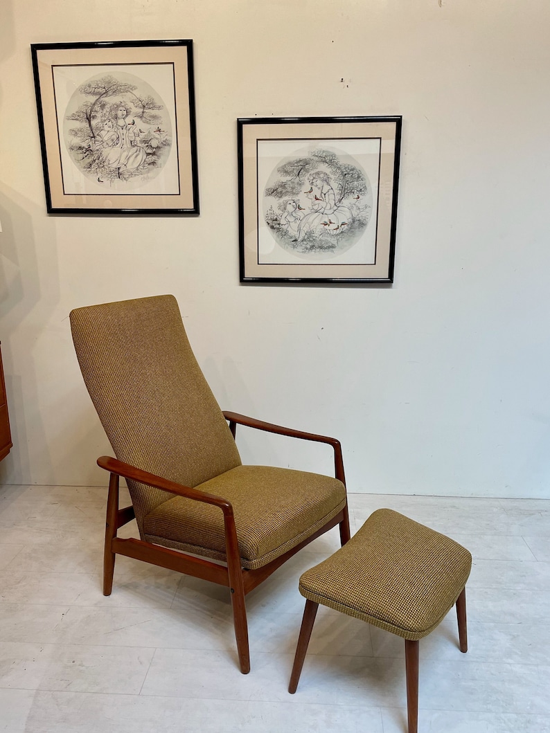 May include: A mid-century modern armchair and ottoman set with a brown tweed fabric and wooden frame. Two framed circular prints with black and white illustrations hang on the wall behind the furniture. The chair has a high back and armrests.