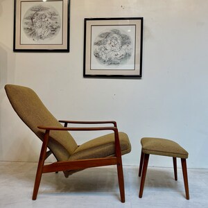 May include: A mid-century modern lounge chair and ottoman set. The chair has a high back and angled arms, with a brown fabric seat and back. The frame is made of wood. The ottoman has a matching fabric top and wooden legs. Two framed circular prints hang on the wall.