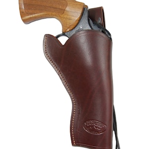 May include: A brown leather holster with a black strap and a brown wooden-handled revolver inside.