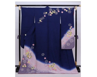 May include: A navy blue kimono with a pink and white ombre design and floral embroidery.