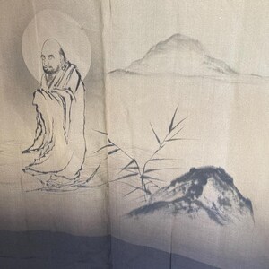 May include: A black and white illustration of a person in a robe sitting in front of a mountain and a bamboo plant. The background is a gradient of light brown to dark blue.