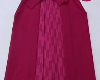 May include: A magenta-colored Japanese hakama with a pleated front panel and a patterned back panel. The hakama is tied at the waist with a sash.