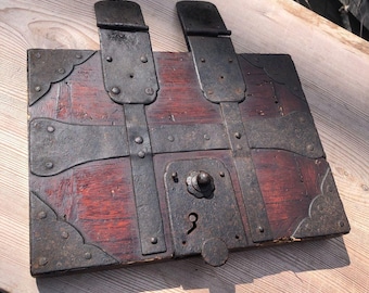 May include: A wooden box with a metal latch and hinges. The box is decorated with metal accents and has a keyhole.