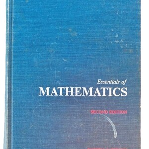 May include: A blue book titled "Essentials of Mathematics" with white text. The cover has the words "MATHEMATICS" in large font, with "SECOND EDITION" and the author's name below.