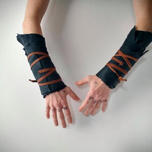 viking style dark sheepskin arm wraps with leather straps
