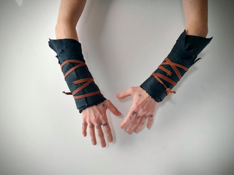 viking style dark sheepskin arm wraps with leather straps