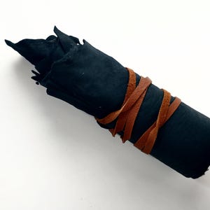 dark sheepskin with leather laces wrapped around it