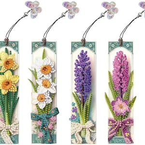 May include: Set of four colorful floral bookmarks with a butterfly charm. Each bookmark features a different flower design: daffodils, hyacinths, and two variations of hyacinths. The bookmarks are made of paper and have a ribbon tie.