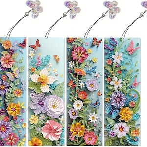 May include: Four floral bookmarks with butterfly charms. Each bookmark features a vibrant design of colorful flowers and butterflies against a light blue background. The bookmarks are adorned with a clear butterfly charm attached by a black string.