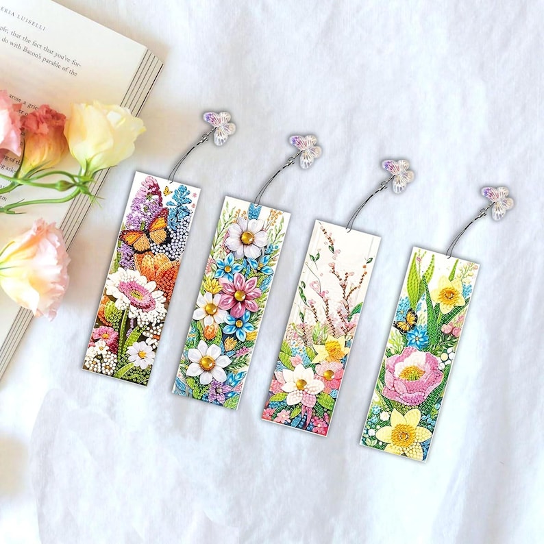 May include: Set of four colorful floral bookmark designs with butterfly accents. Each bookmark features a different floral arrangement with a variety of colors and patterns.
