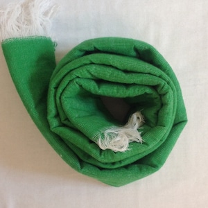 Handwoven green wool scarf.