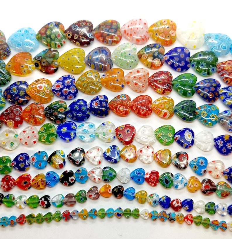 May include: A strand of colorful heart-shaped glass beads with a variety of patterns and colors, including red, blue, green, yellow, and white.