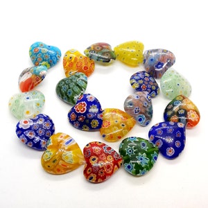 May include: A collection of colorful heart-shaped glass beads with intricate floral patterns. The beads are made of Murano glass and are perfect for jewelry making or crafting.