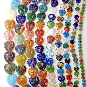 May include: A collection of colorful heart-shaped glass beads with intricate patterns. The beads are strung together on a string and are perfect for jewelry making or crafting.