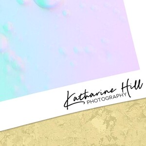 May include: An abstract photograph in pastel shades of blue, green, and lilac, with a blurred, dreamlike effect. The artist's signature, "Katharine Hill PHOTOGRAPHY," is in black script in the lower right corner of the image.