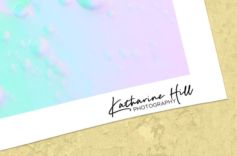 May include: An abstract photograph in pastel shades of blue, green, and lilac, with a blurred, dreamlike effect. The artist's signature, "Katharine Hill PHOTOGRAPHY," is in black script in the lower right corner of the image.