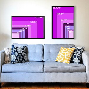May include: Two framed art prints with a gradient of purple shades, labelled with dimensions in inches. The prints are displayed above a light blue sofa with decorative cushions. The text on the prints includes sizes such as 20x30, 16x24, 12x18, 10x15, 8x12, 6x9, and 5x7.5.