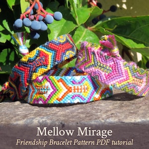 May include: Three colorful friendship bracelets with geometric patterns, including red, yellow, blue, green, pink, and white threads. The bracelets are on a stone surface with the text "Mellow Mirage Friendship Bracelet Pattern PDF tutorial".