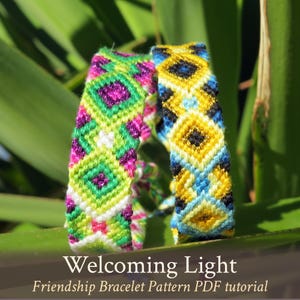 May include: Two friendship bracelets with colorful geometric patterns. The bracelet on the left is green, pink, white, and purple. The bracelet on the right is yellow, blue, and black. The bracelets are on a green leaf. Welcoming Light Friendship Bracelet Pattern PDF tutorial.