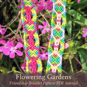 May include: Two colorful friendship bracelets with a geometric pattern, featuring pink, green, yellow, and blue threads. The bracelets are photographed against a background of pink flowers and green foliage. The text "Flowering Gardens Friendship Bracelet Pattern PDF tutorial" is displayed below the bracelets.