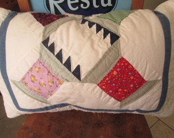 Quilted pillow made from a vintage quilt with hand stitching