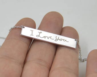 May include: Silver necklace with a rectangular pendant that says "I Love You" in cursive handwriting.